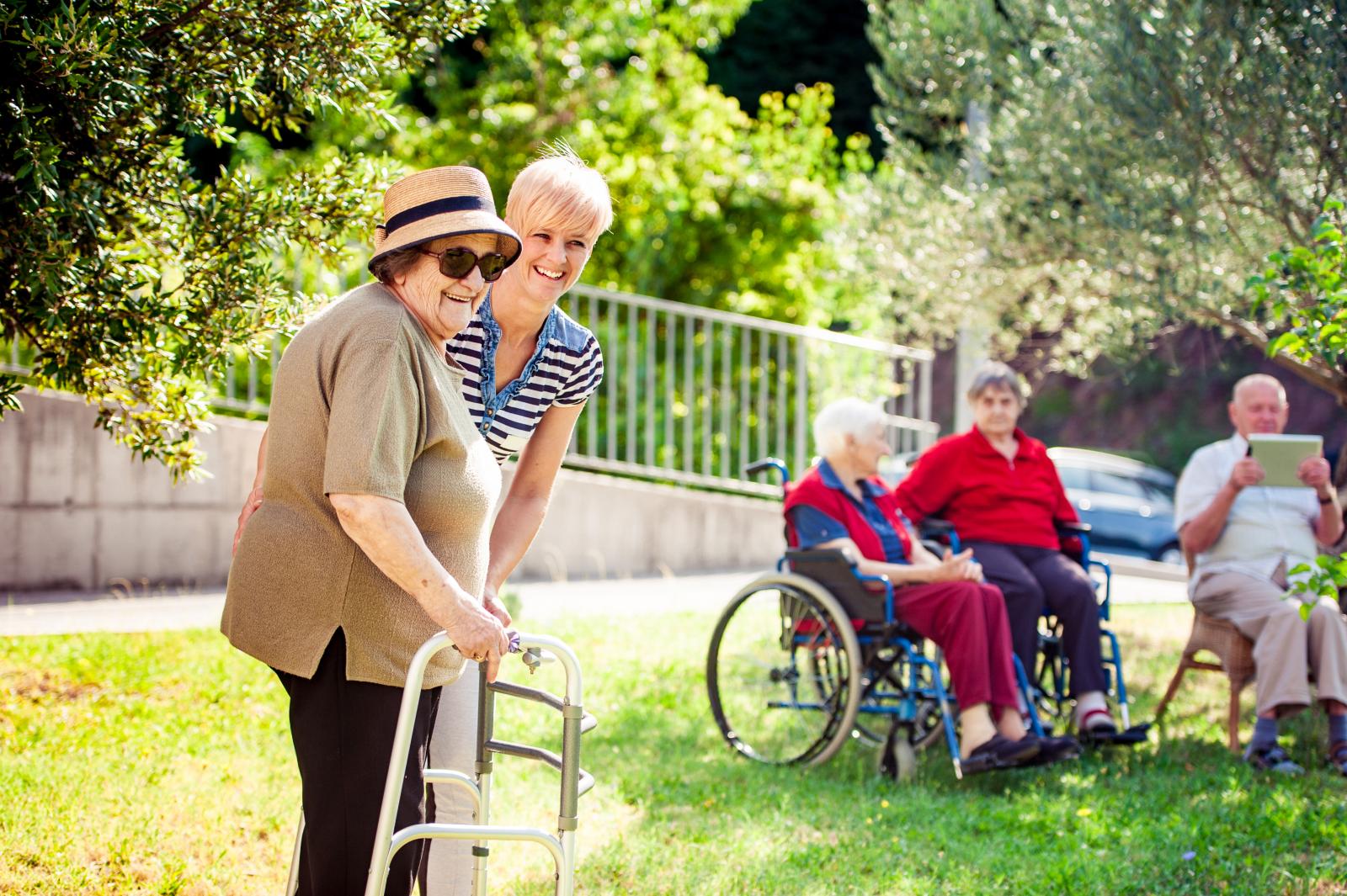 women with walker and aide